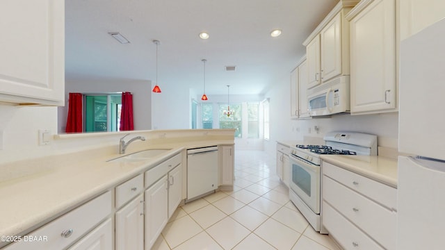 kitchen with sink, decorative light fixtures, light tile patterned floors, kitchen peninsula, and white appliances