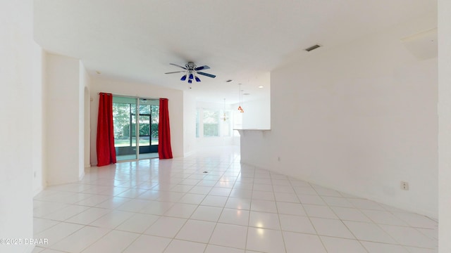 spare room with ceiling fan and light tile patterned flooring