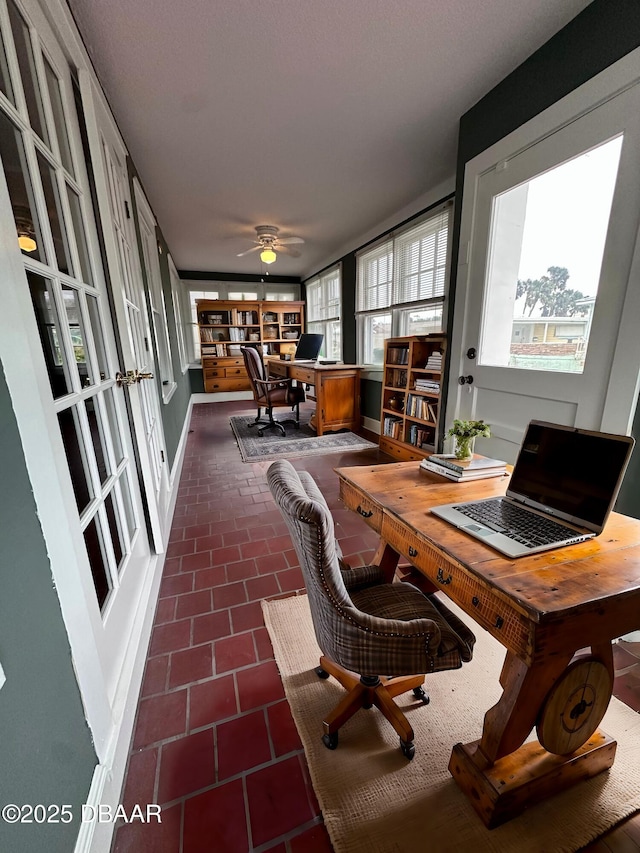 sunroom / solarium featuring ceiling fan