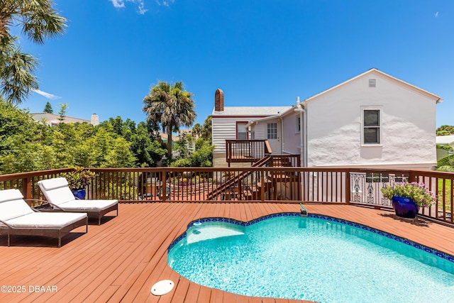 view of swimming pool with a deck