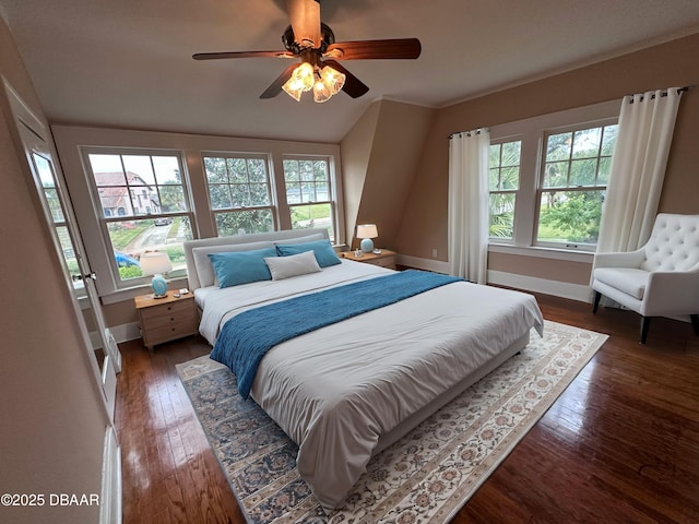 bedroom featuring vaulted ceiling, ceiling fan, and dark hardwood / wood-style flooring