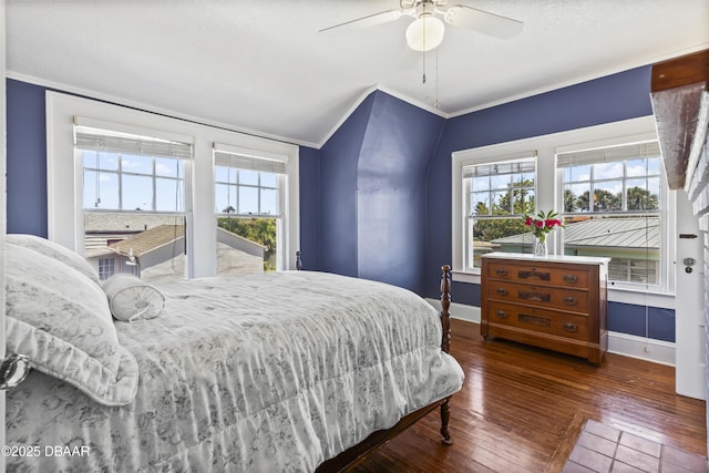 bedroom featuring crown molding, ceiling fan, dark hardwood / wood-style flooring, and vaulted ceiling