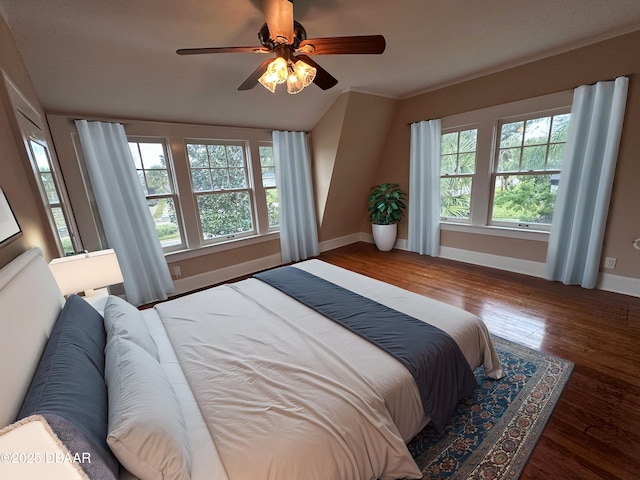 bedroom featuring ceiling fan, lofted ceiling, and dark hardwood / wood-style flooring