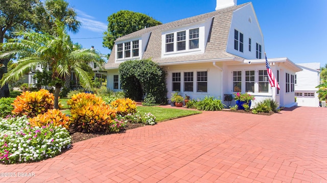 rear view of property with a garage