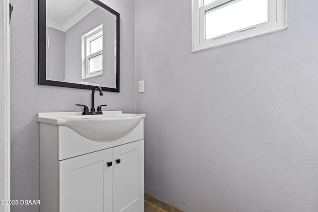 bathroom with crown molding and vanity