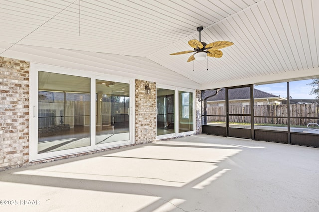 unfurnished sunroom with lofted ceiling and ceiling fan