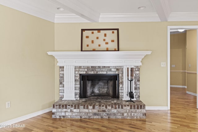 interior details featuring a brick fireplace, beamed ceiling, and wood finished floors