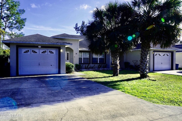 ranch-style home with an attached garage, a front lawn, concrete driveway, and stucco siding