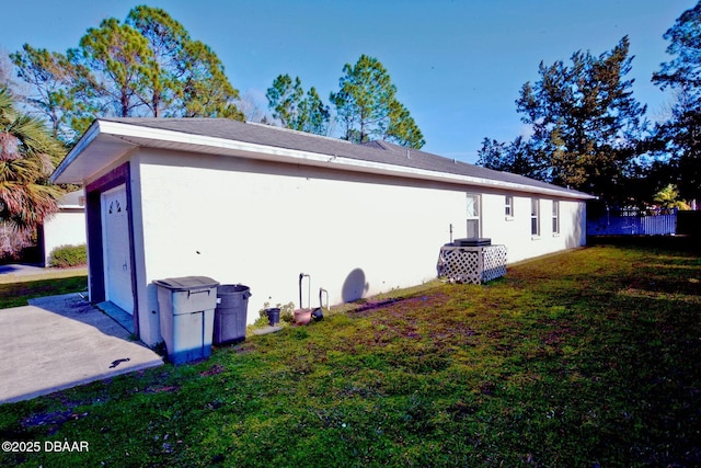 view of property exterior with a lawn and stucco siding