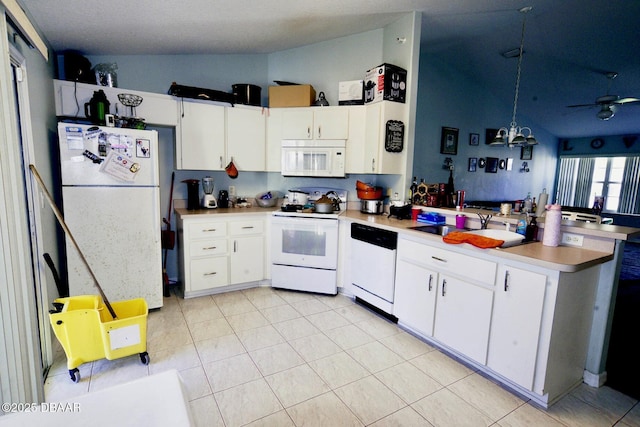 kitchen with a peninsula, white appliances, white cabinetry, and lofted ceiling