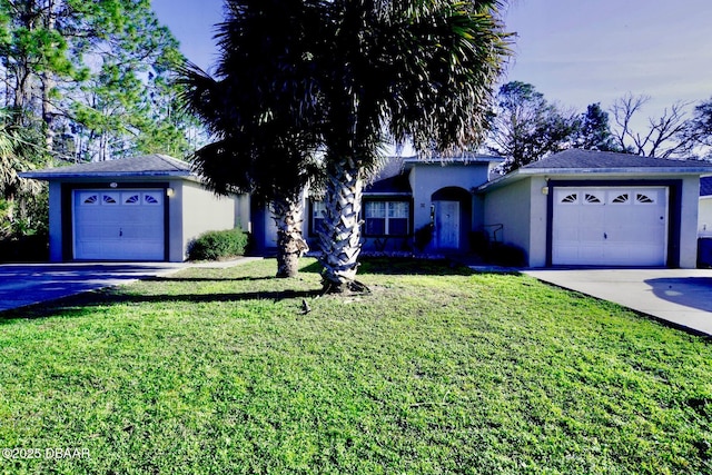 ranch-style home with a garage, a front yard, driveway, and stucco siding