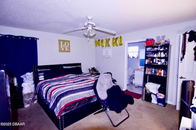 carpeted bedroom featuring ceiling fan, a textured ceiling, and ensuite bathroom