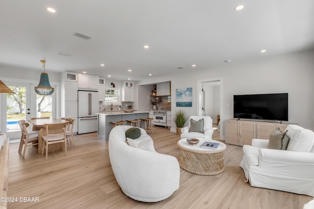 living room with light hardwood / wood-style floors and french doors