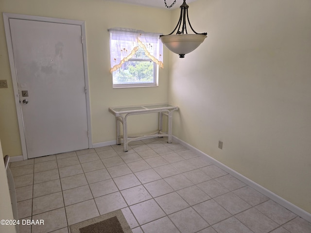 unfurnished dining area featuring light tile patterned floors