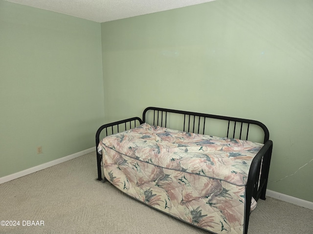 carpeted bedroom featuring a textured ceiling