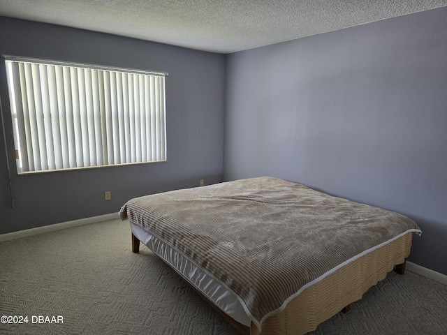 carpeted bedroom with a textured ceiling