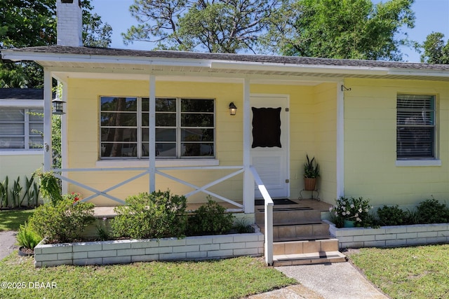 38 Lorillard Pl, Ormond Beach, FL 32174 - view of exterior entry featuring a chimney