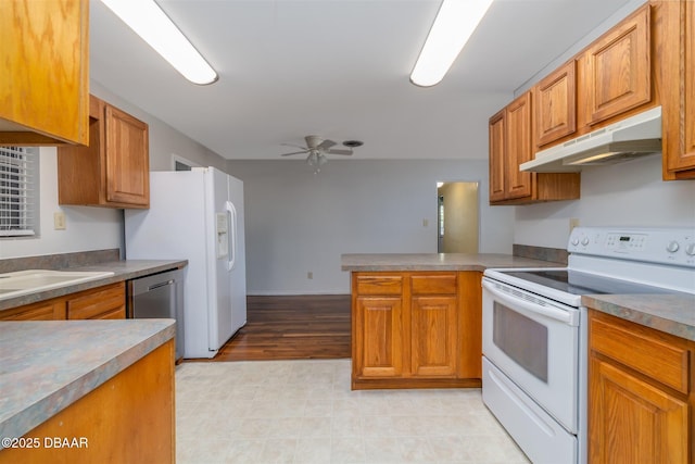 38 Lorillard Pl, Ormond Beach, FL 32174 - kitchen with white appliances, under cabinet range hood, a peninsula, ceiling fan, and brown cabinets
