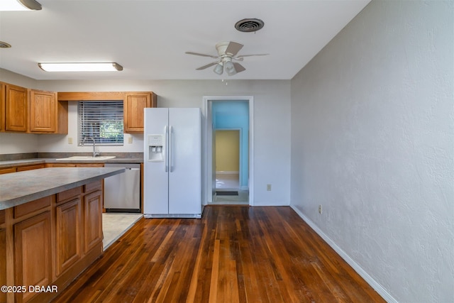 38 Lorillard Pl, Ormond Beach, FL 32174 - kitchen with white refrigerator with ice dispenser, dishwasher, hardwood / wood-style flooring, ceiling fan, and brown cabinets