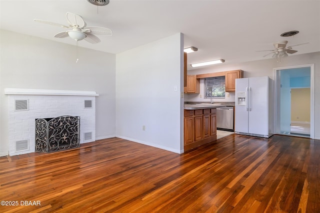 38 Lorillard Pl, Ormond Beach, FL 32174 - unfurnished living room with a ceiling fan, dark wood-type flooring, and a brick fireplace