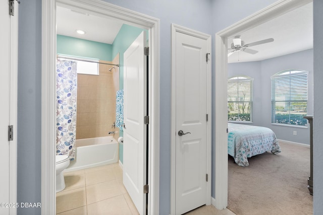 full bath featuring toilet, shower / bath combo, tile patterned flooring, baseboards, and ceiling fan