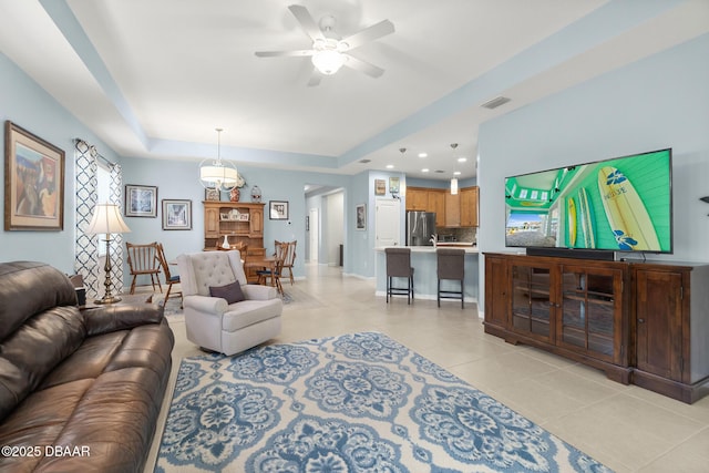 living area featuring visible vents, a ceiling fan, recessed lighting, light tile patterned flooring, and a raised ceiling