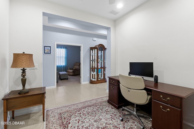 office area featuring light tile patterned floors, visible vents, and baseboards