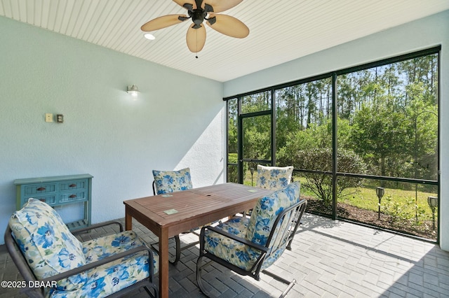 sunroom featuring a ceiling fan