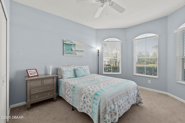 carpeted bedroom with baseboards and ceiling fan