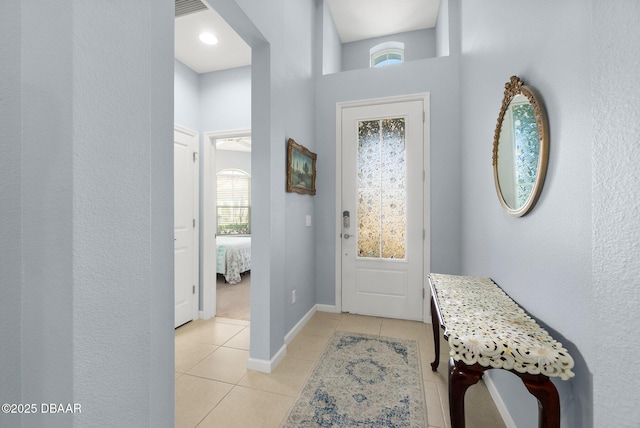 entryway featuring light tile patterned flooring, visible vents, and baseboards