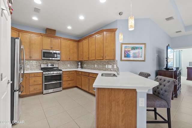 kitchen with visible vents, a peninsula, stainless steel appliances, and a sink