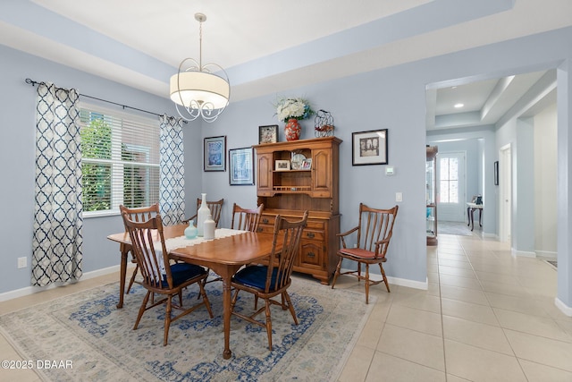 dining area with light tile patterned flooring, recessed lighting, a raised ceiling, and baseboards