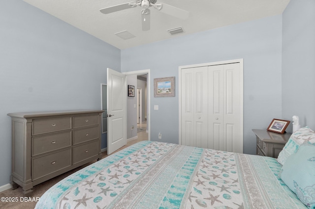 carpeted bedroom with a closet, visible vents, baseboards, and a ceiling fan