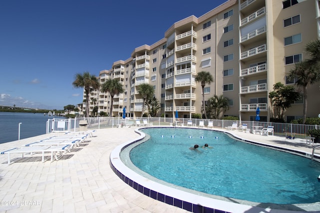 view of swimming pool with a water view