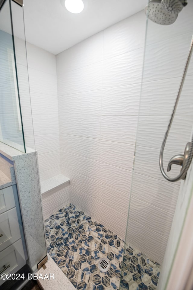 bathroom featuring vanity and tiled shower