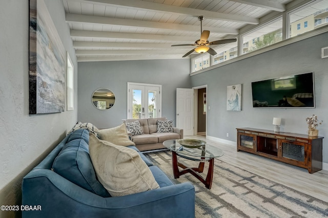 living room featuring vaulted ceiling with beams, ceiling fan, light hardwood / wood-style flooring, and french doors