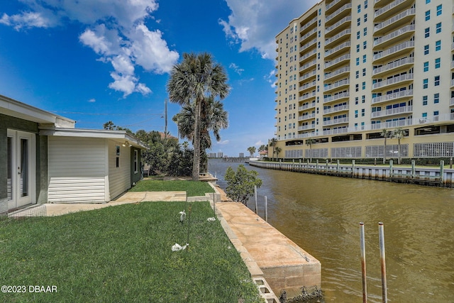 exterior space with a water view and a lawn