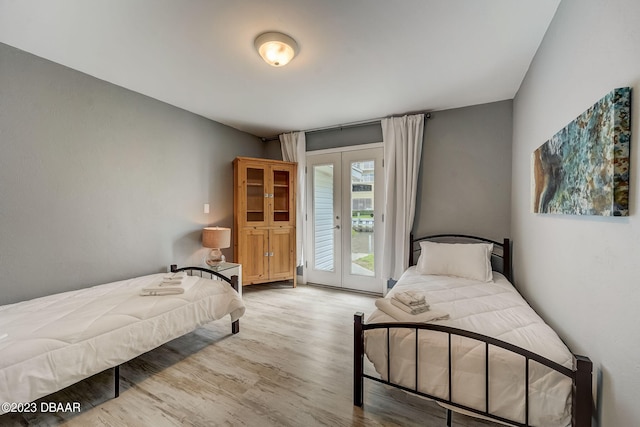 bedroom with access to exterior, french doors, and light wood-type flooring