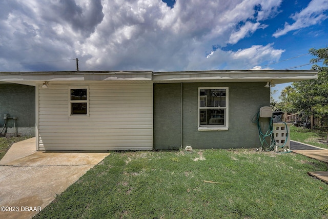 rear view of property featuring a lawn