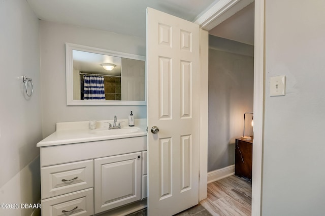 bathroom featuring hardwood / wood-style flooring and vanity