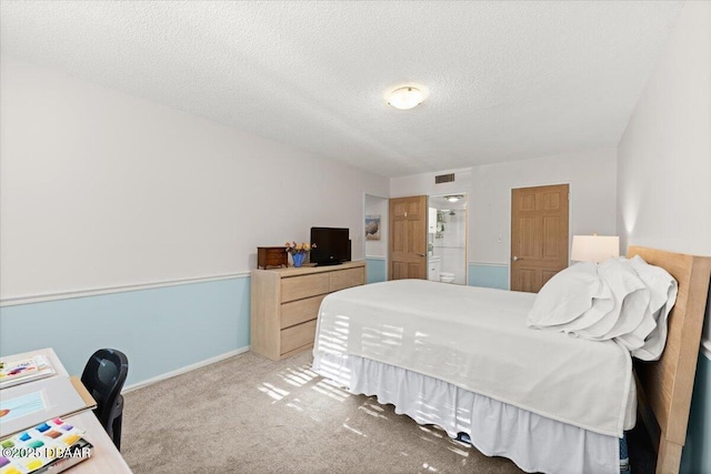 bedroom with carpet floors and a textured ceiling