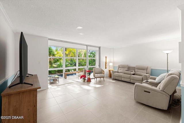 living room featuring light tile patterned floors, a textured ceiling, expansive windows, and crown molding