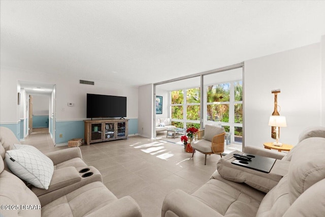 living room with light tile patterned floors and expansive windows