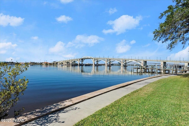 dock area featuring a water view and a yard