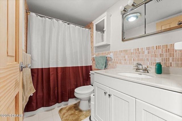 bathroom with tile patterned flooring, vanity, toilet, and tile walls