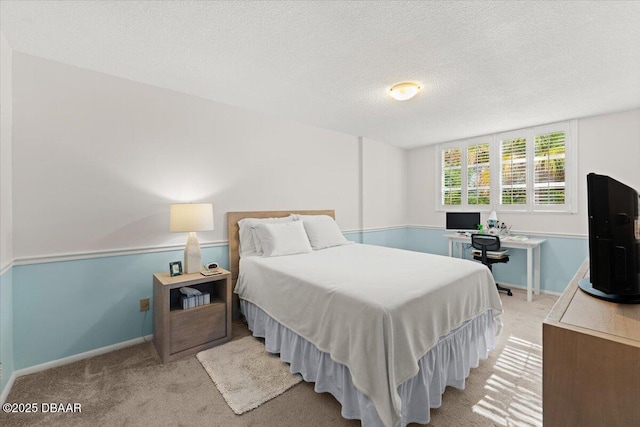 carpeted bedroom featuring a textured ceiling