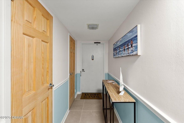 corridor featuring light tile patterned floors