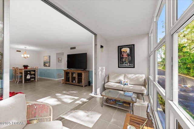 living room featuring light tile patterned floors and a chandelier