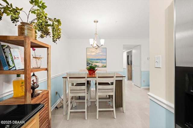 dining room with crown molding and a chandelier