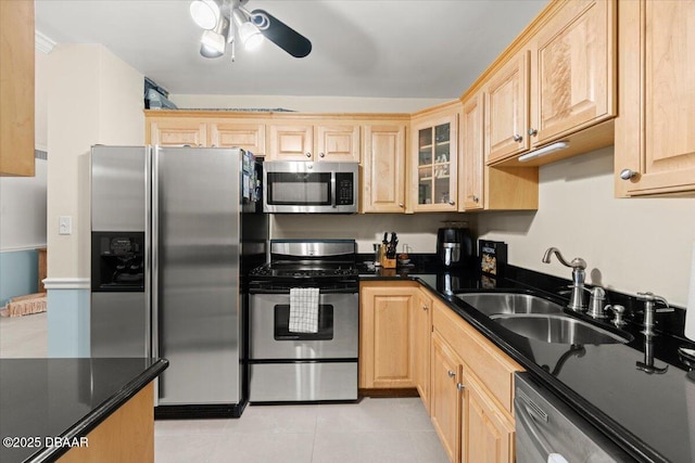 kitchen featuring appliances with stainless steel finishes, light brown cabinetry, ceiling fan, sink, and light tile patterned floors